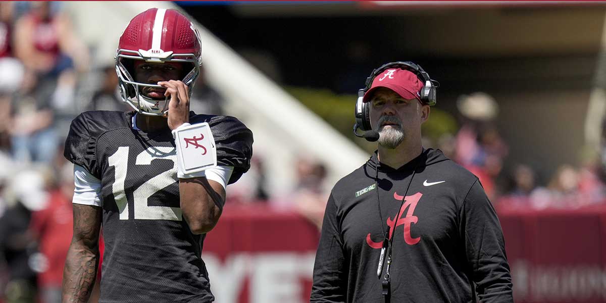 Alabama quarterback Keelon Russell (12) stands with Alabama offensive coordinator Ryan Grubb during A-Day drills at Bryant-Denny Stadium.