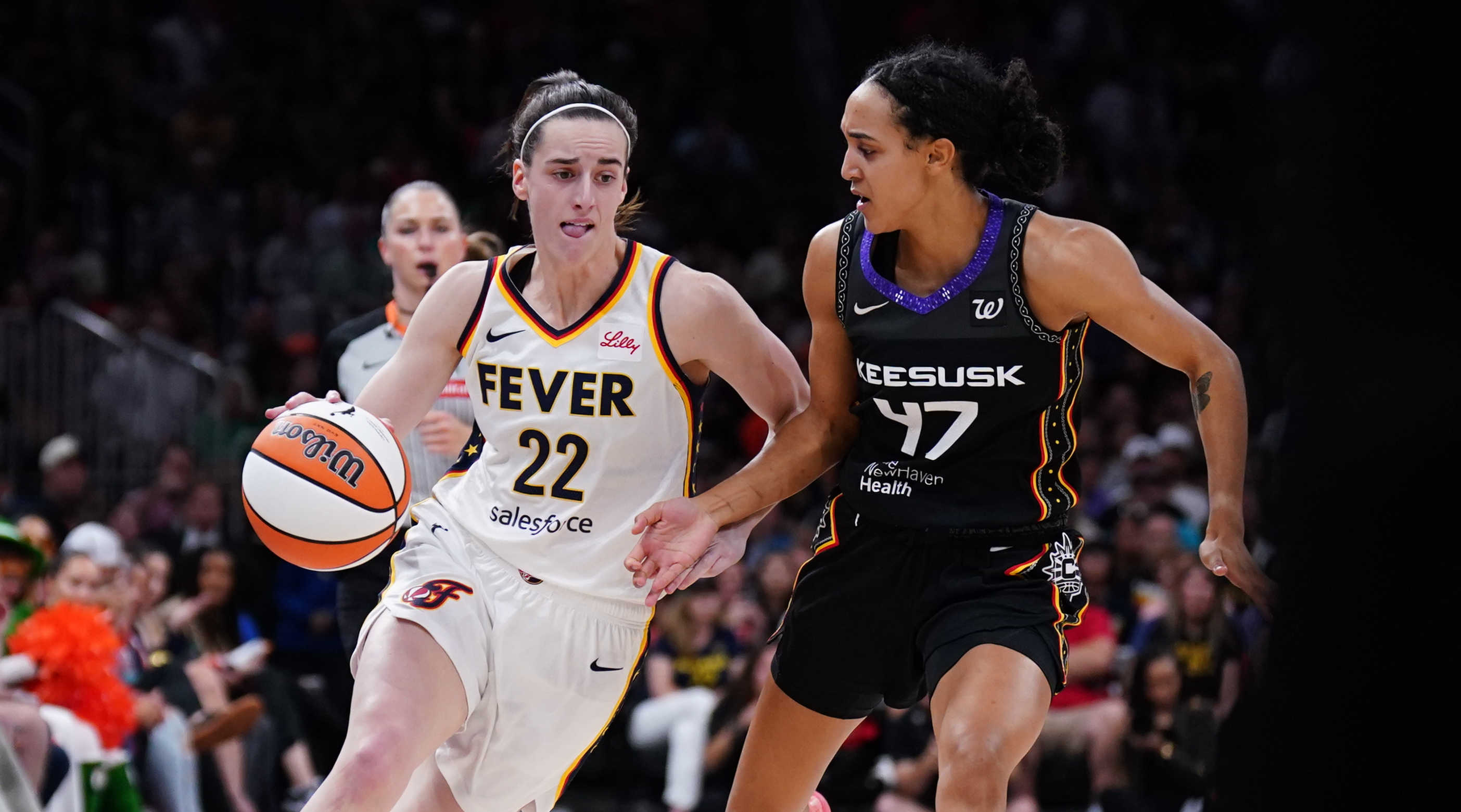 Indiana Fever guard Caitlin Clark (22) drives the ball against Connecticut Sun guard Leila Lacan (47) in the second quarter at TD Garden.