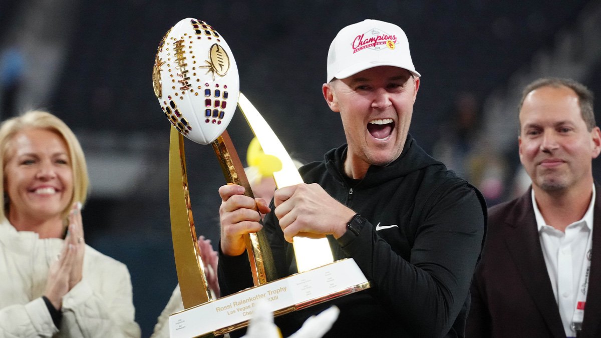 Southern California Trojans head coach Lincoln Riley holds the championship trophy after the game against the Texas A&M Aggies at Allegiant Stadium.