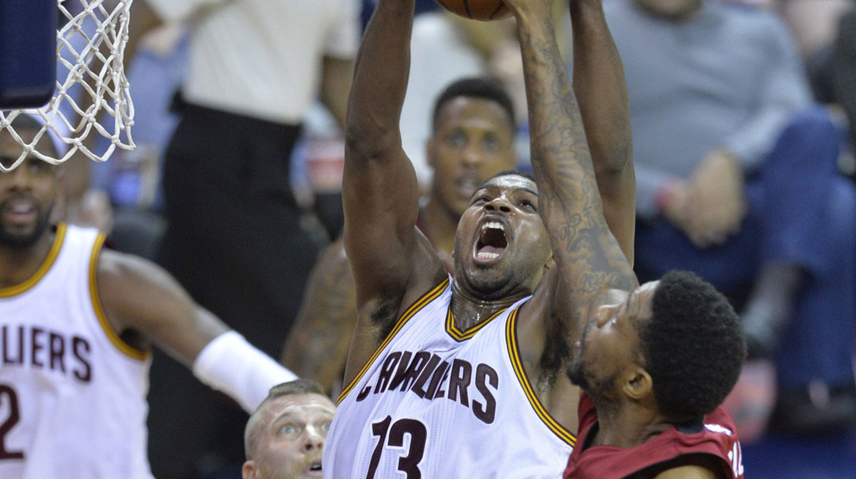 Cleveland Cavaliers center Tristan Thompson (13) grabs a rebound between Miami Heat forward Chris Andersen (left) and forward Udonis Haslem (40) in the third quarter at Quicken Loans Arena.