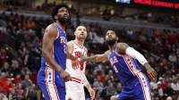 Philadelphia 76ers center Joel Embiid (21) and forward Paul George (8) defend against Chicago Bulls center Nikola Vucevic (9) during the first half at United Center.