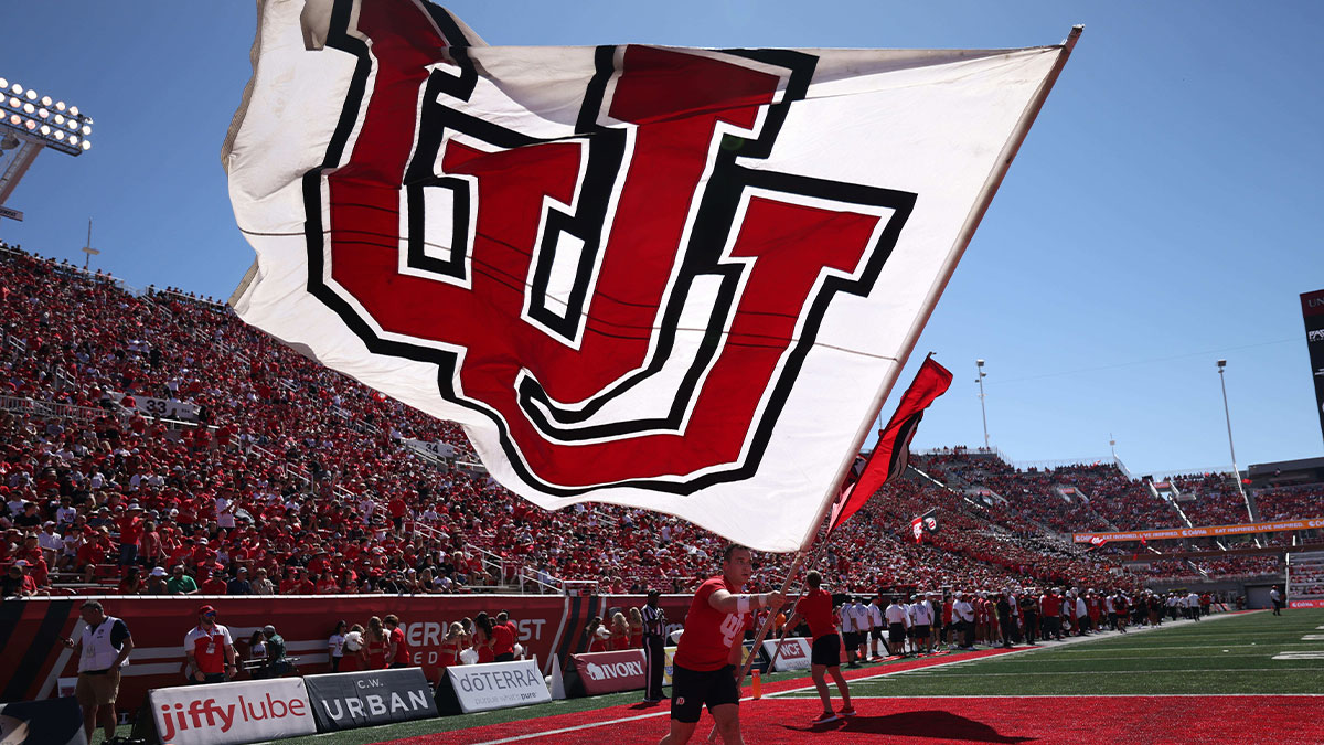 The Utah Utes cheer team waves a flag after a touchdown against the Weber State Wildcats in the first half at Rice-Eccles Stadium.