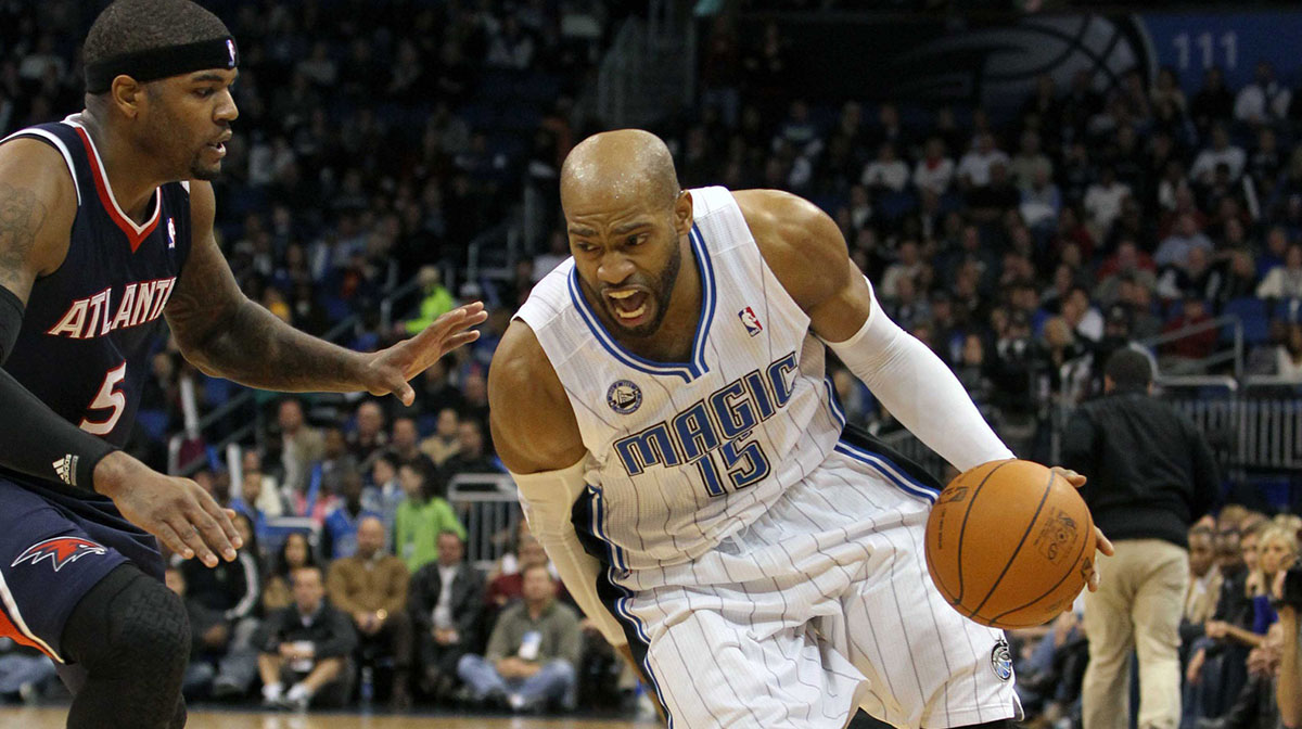 Orlando Magic shooting guard Vince Carter (15) drives past Atlanta Hawks power forward Josh Smith (5) during the second half at Amway Center. Atlanta Hawks defeated the Orlando Magic 80-74.