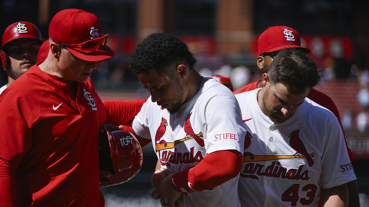 St. Louis Cardinals first baseman Willson Contreras (40) is held back by hitting coach Brant Brown (73) and catcher Pedro Pages (43) after he exchanged words with Chicago Cubs relief pitcher Daniel Palencia (not pictured) after the Cubs defeated the Cardinals at Busch Stadium.