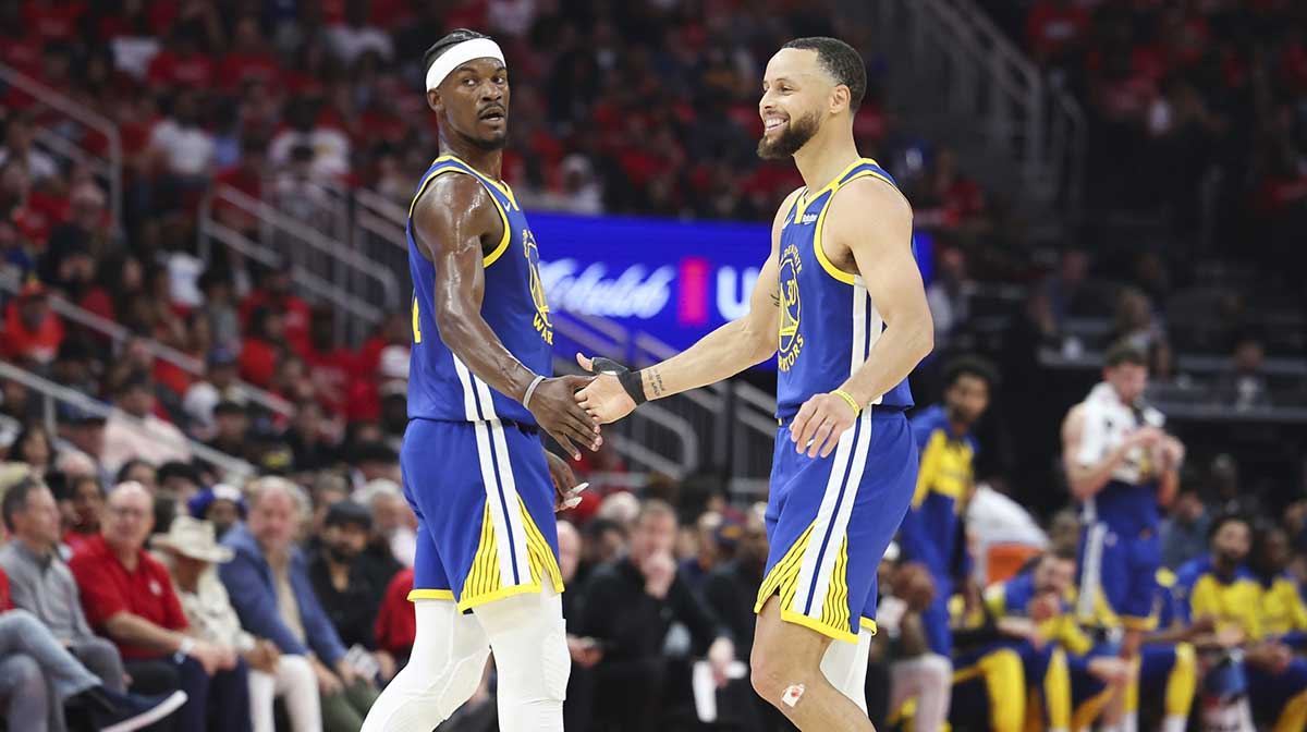 Warriors guard Stephen Curry (30) celebrates with forward Jimmy Butler III (10) after a play during the second quarter against the Houston Rockets at Toyota Center
