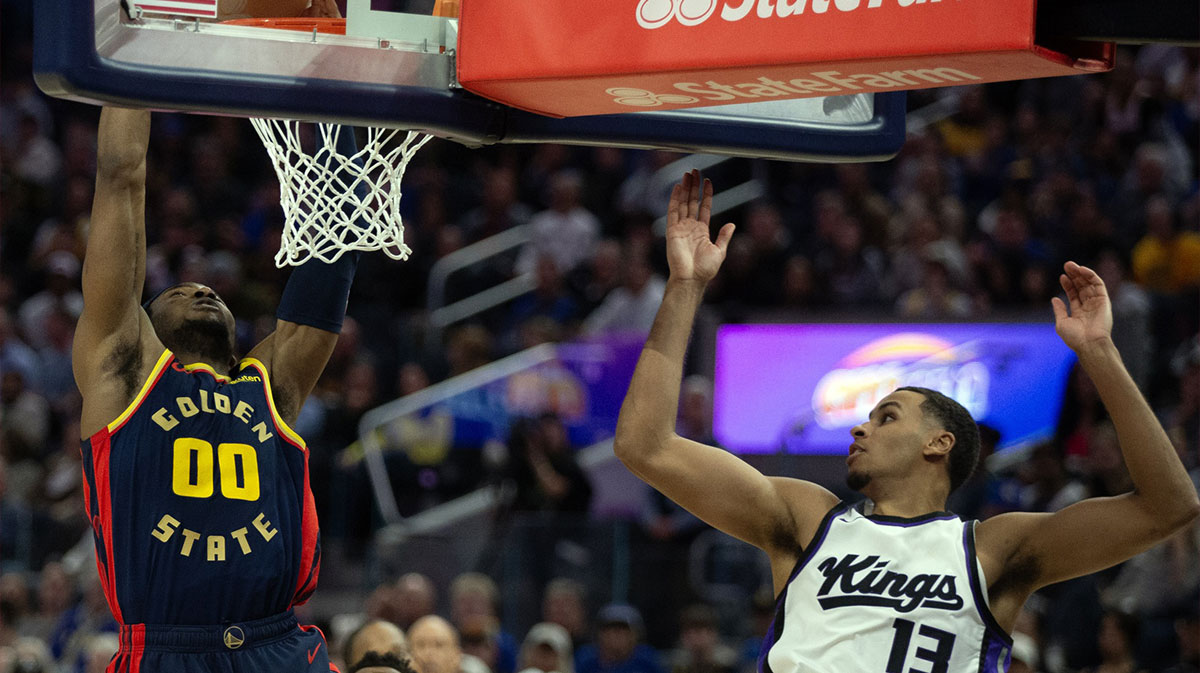 Golden State Warriors forward Jonathan Kuminga (00) dunks ahead of Sacramento Kings forward Isaac Jones (3) during the fourth quarter at Chase Center.