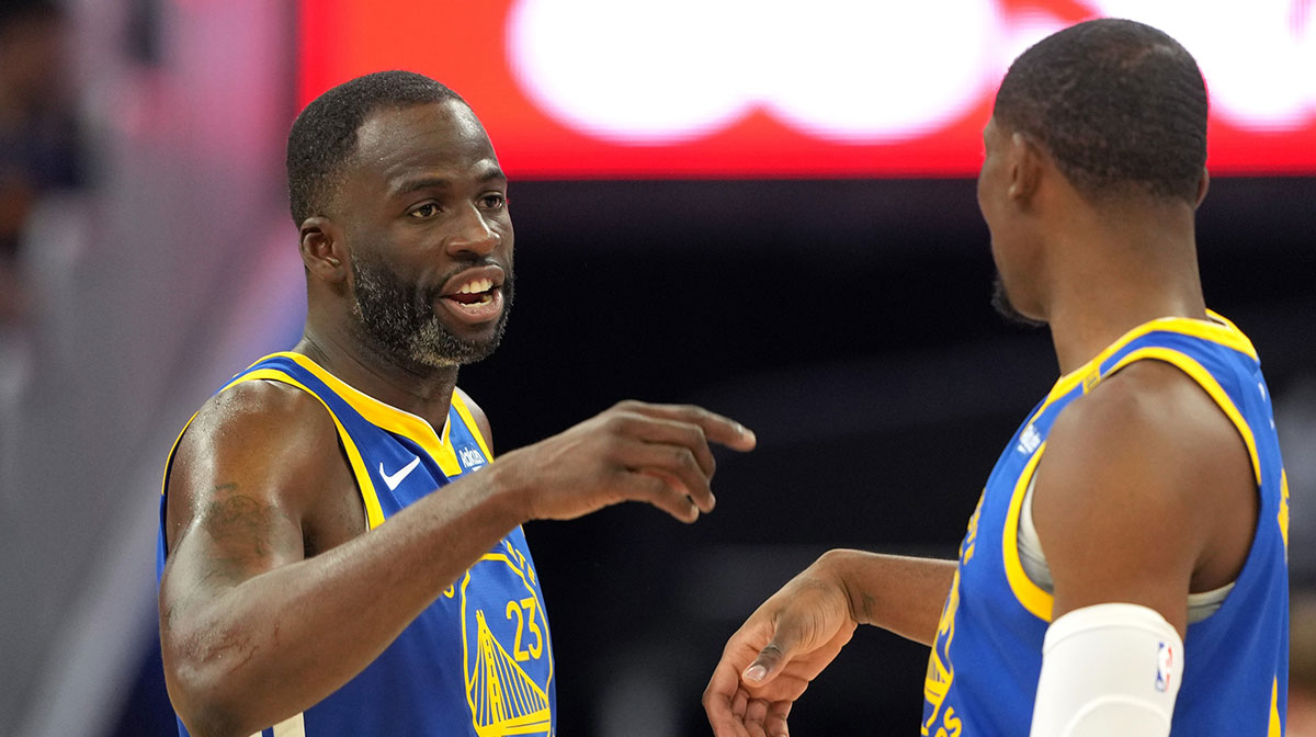 Golden State Warriors forward Draymond Green (23) talks with forward Jonathan Kuminga (right) during the third quarter against the Los Angeles Lakers at Chase Center.