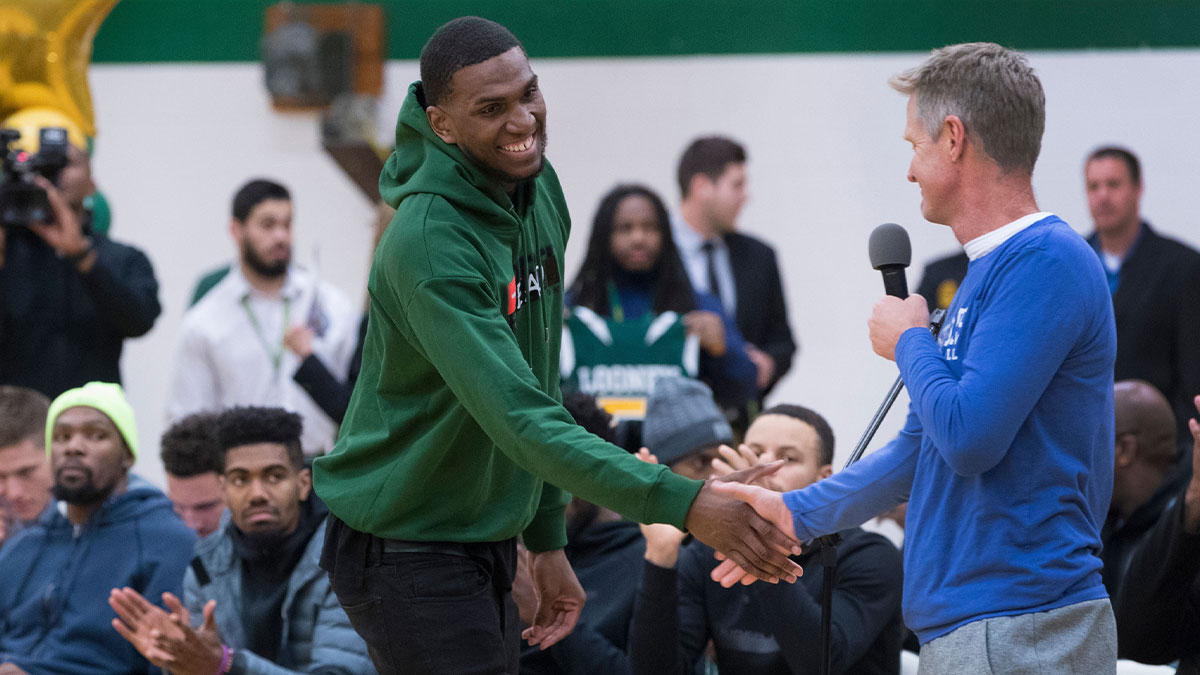 Golden State Warrior center Kevon Looney (left) is introduced by his current head coach, Steve Kerr,while taking part in a ceremony where his jersey is retired Thursday, December 6, 2018 at Hamilton High School.