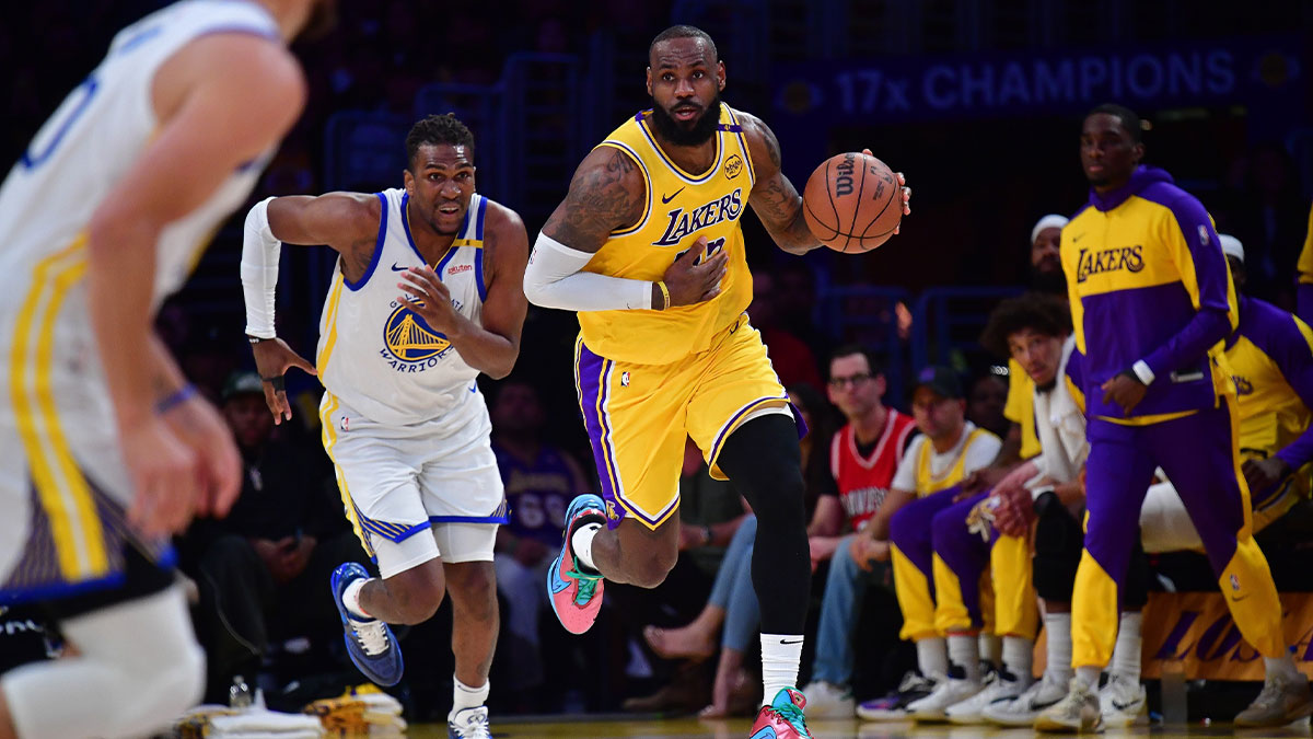 Los Angeles Lakers forward LeBron James (23) moves the ball up court ahead of Golden State Warriors forward Kevon Looney (5) during the first half at Crypto.com Arena.