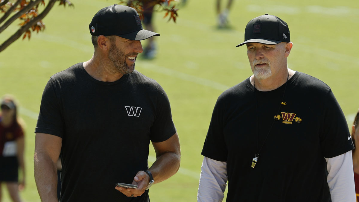 Washington Commanders general manager Adam Peters (L) talks with Commanders head coach Dan Quinn (R) while walking off the practice field on day two of training camp at OrthoVirginia Training Center at Commanders Park.