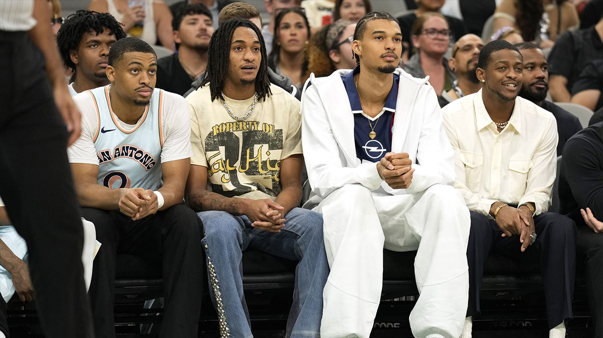 San Antonio Spurs (from left to right) forward Keldon Johnson (0), guard Devin Vassell (24), center Victor Wembanyama (1) and guard De'Aron Fox (4) watch the first half of a game against the Toronto Raptors at Frost Bank Center.