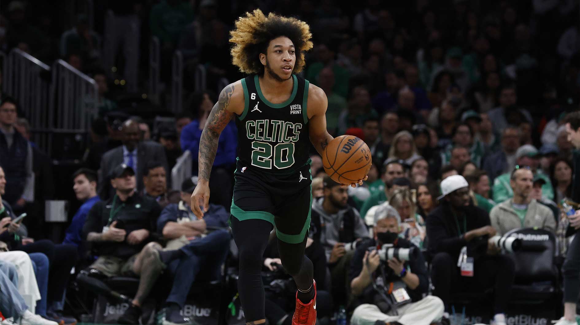 Boston Celtics guard JD Davison (20) brings the ball up the court against the Toronto Raptors during the second half at TD Garden.