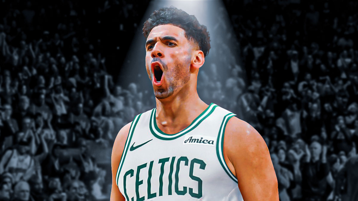 Georges Niang looking serious (in a celtics jersey) with a spotlight on him