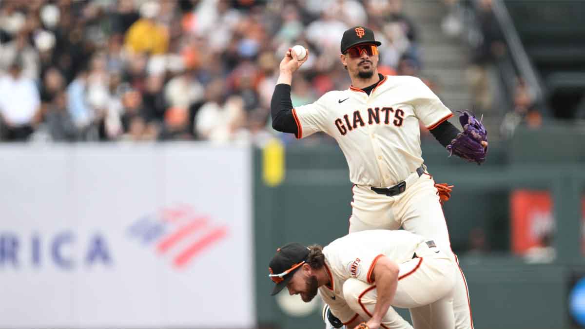 San Francisco Giants shortstop Willy Adames (2) throws to first base for an out over second baseman Brett Wisely (0) against the Pittsburgh Pirates in the tenth inning at Oracle Park.