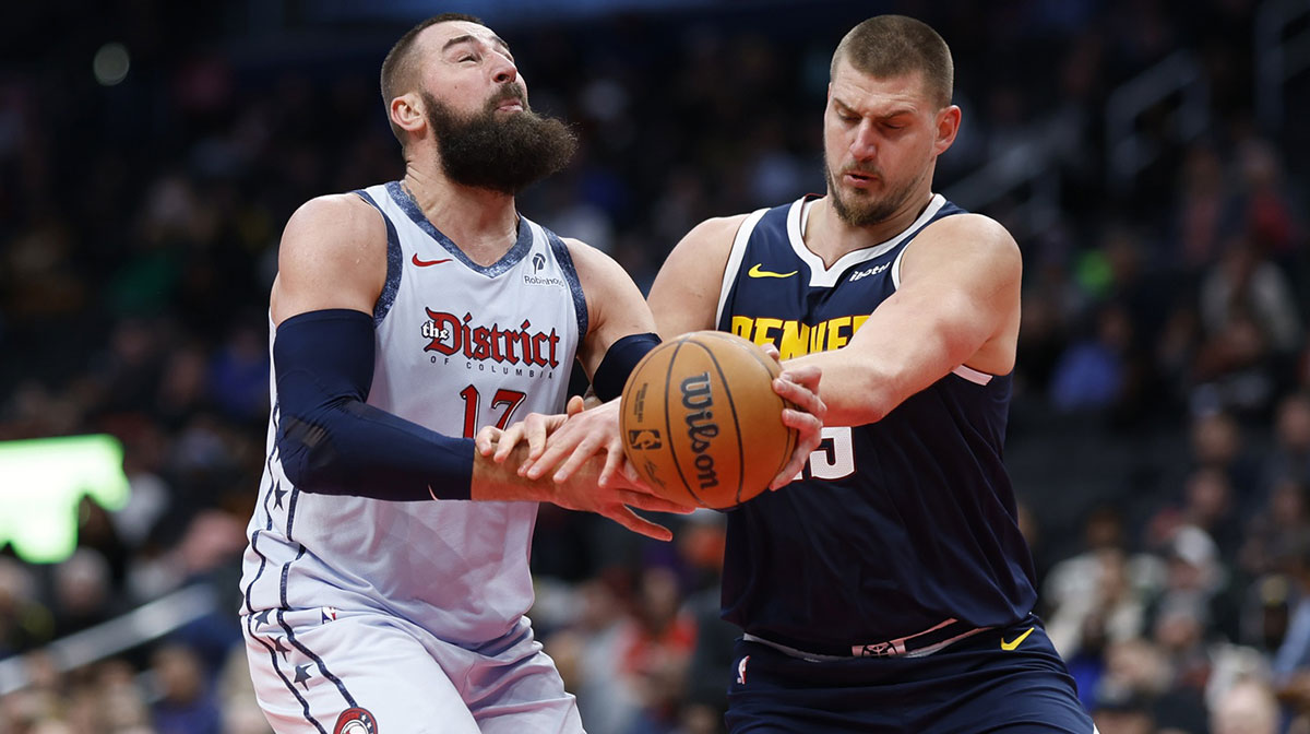 Washington Wizards center Jonas Valanciunas (17) is fouled while driving to the basket by Denver Nuggets center Nikola Jokic (15) in the third quarter at Capital One Arena.