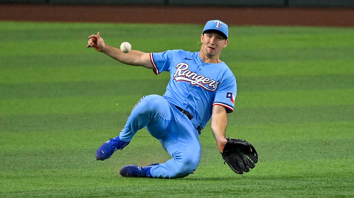 Sep 22, 2024; Arlington, Texas, USA; Texas Rangers left fielder Wyatt Langford (36) slides but cannot make the catch of a ball hit by Seattle Mariners right fielder Victor Robles (not pictured) during the sixth inning at Globe Life Field. Mandatory Credit: Jerome Miron-Imagn Images