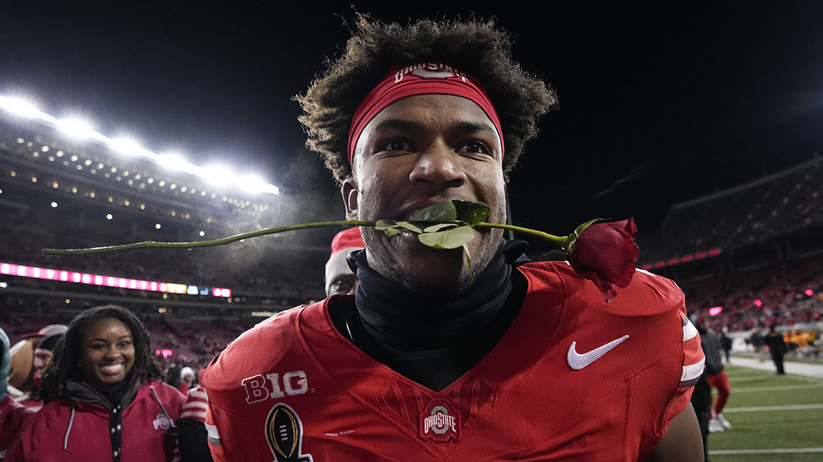 Ohio State Buckeyes safety Caleb Downs leaves the field with a rose in his mouth following the 42-17 win over the Tennessee Volunteers in the College Football Playoff first round game at Ohio Stadium in Columbus on Dec. 21, 2024. Ohio State will face Oregon in the Rose Bowl.