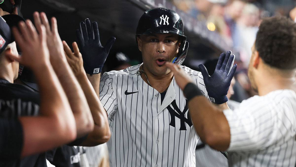New York Yankees designated hitter Giancarlo Stanton (27) celebrates with teammates after hitting a solo home run during the sixth inning against the Philadelphia Phillies at Yankee Stadium.