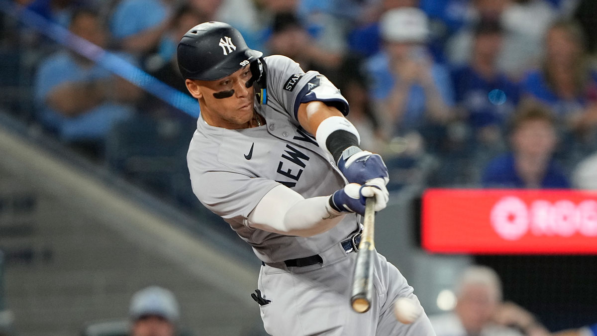 New York Yankees designated hitter Aaron Judge (99) hits a single against the Toronto Blue Jays during the seventh inning at Rogers Centre.