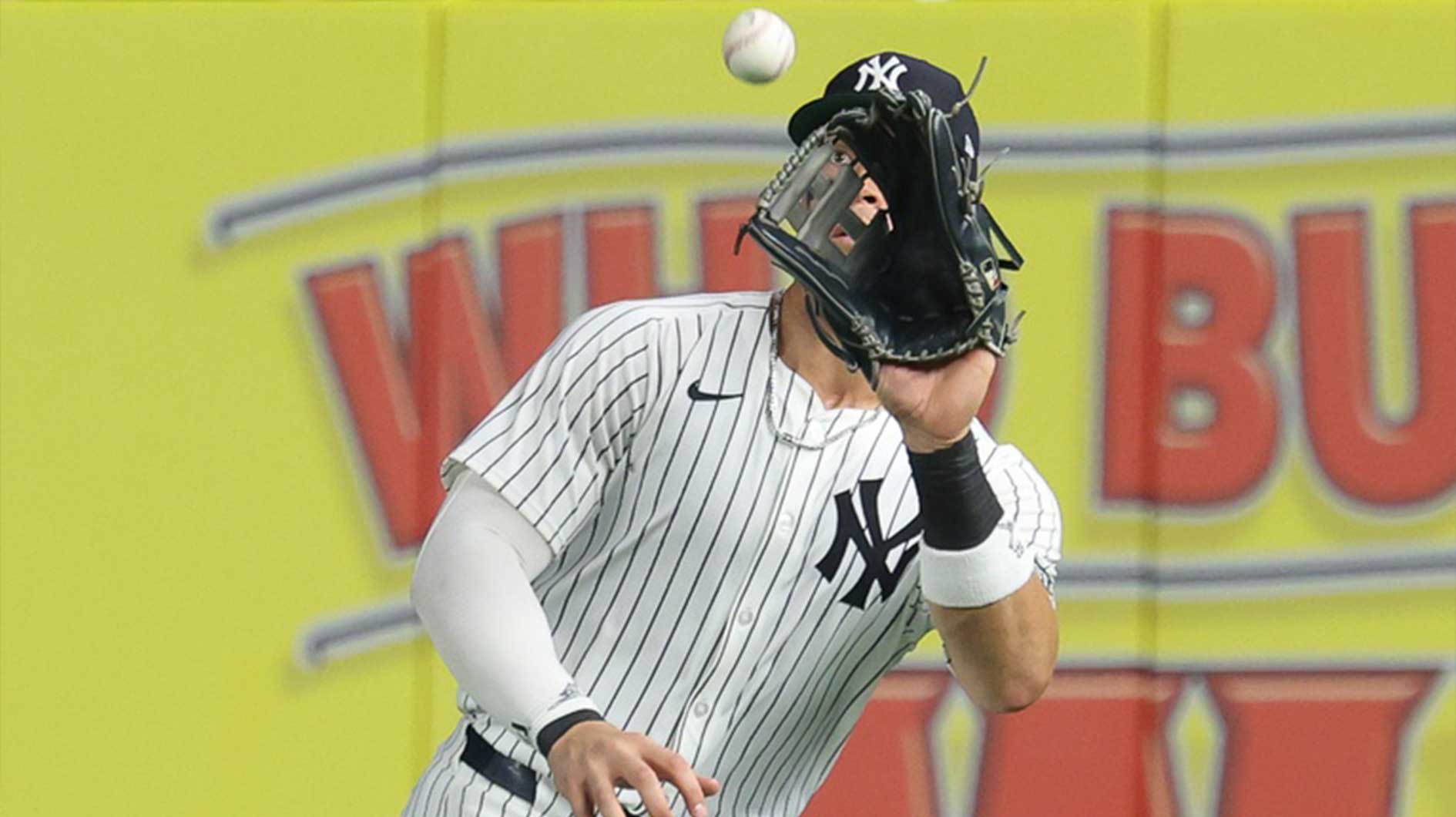 New York Yankees right fielder Aaron Judge (99) makes a catch for an out during the ninth inning against the Philadelphia Phillies at Yankee Stadium.