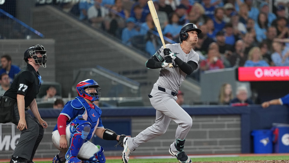 New York Yankees left fielder Cody Bellinger (35) hits a home run against the Toronto Blue Jays during the eighth inning at Rogers Centre.