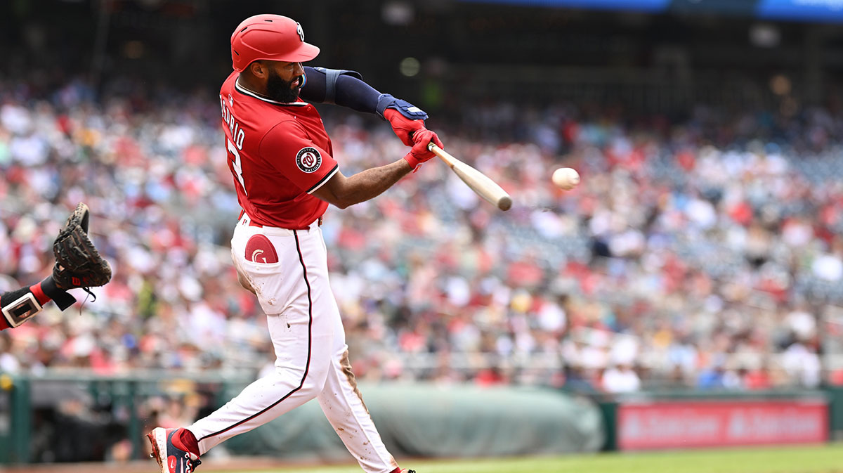 Washington Nationals third baseman Amed Rosario (13) hits the ball into play against the Boston Red Sox during the fourth inning at Nationals Park.