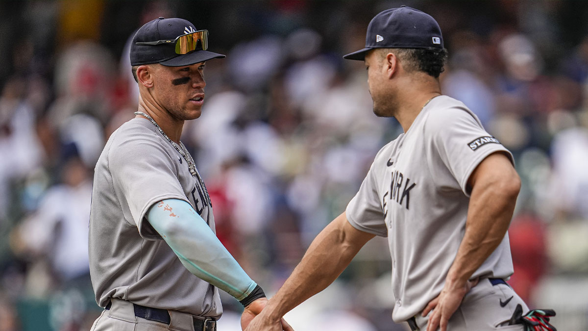New York Yankees right fielder Aaron Judge (99) and designated hitter Giancarlo Stanton (27) react after defeating the Atlanta Braves at Truist Park.