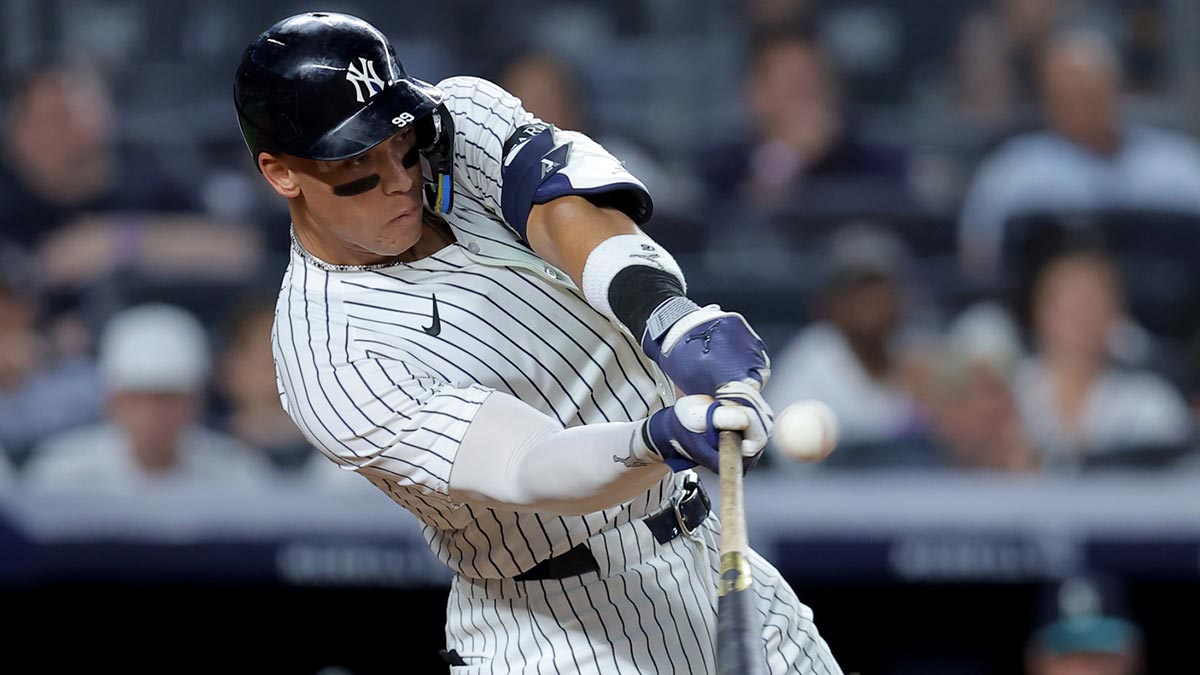 New York Yankees right fielder Aaron Judge (99) hits a solo home run against the Seattle Mariners during the seventh inning at Yankee Stadium.