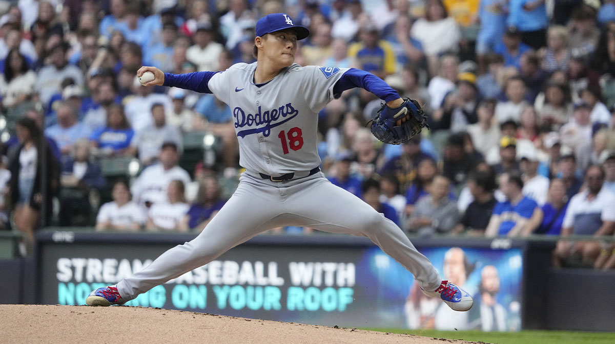 Jul 7, 2025; Milwaukee, Wisconsin, USA; Los Angeles Dodgers pitcher Yoshinobu Yamamoto (18) delivers a pitch against the Milwaukee Brewers in the first inning at American Family Field.