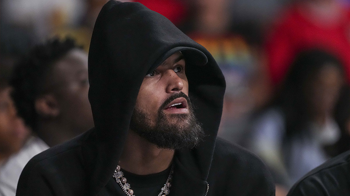Atlanta Hawks player Trae Young watches the game between the Atlanta Dream against the Minnesota Lynx during the first half at Gateway Center Arena at College Park