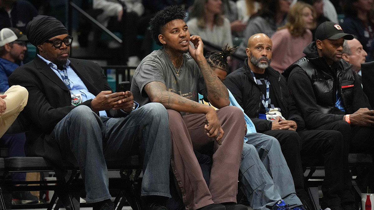 Nick Young (center) watches during the Legends of Basketball Las Vegas Invitational between the Southern California Trojans and the Gonzaga Bulldogs at MGM Grand Garden Arena