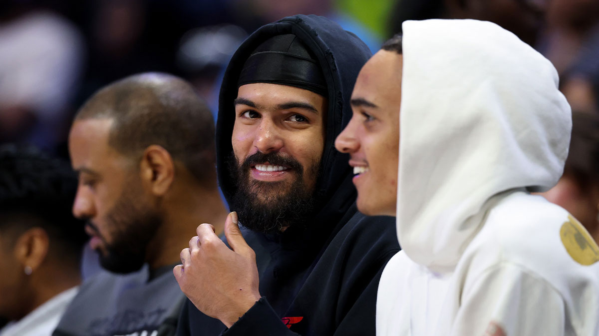 Atlanta Hawks point guard Trae Young (middle) watches the game between the Dallas Wings and Golden State Valkyries at College Park Center.