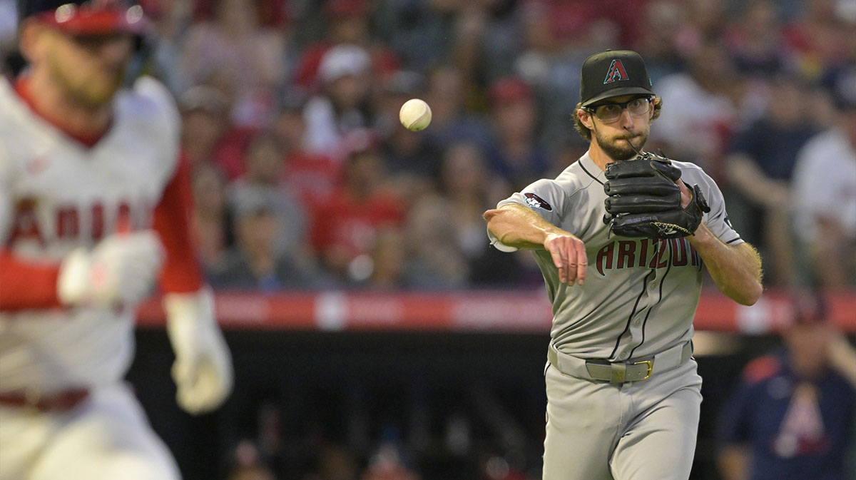 Arizona Diamondbacks starting pitcher Zac Gallen (23) throws Los Angeles Angels left fielder Taylor Ward (3) out at first base during the fifth inning at Angel Stadium.