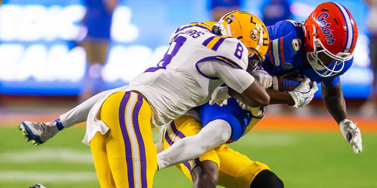 LSU Tigers cornerback Zy Alexander (14) and LSU Tigers safety Major Burns (8) throw Florida Gators wide receiver Elijhah Badger (6) to the ground during the second half at Ben Hill Griffin Stadium in Gainesville, FL on Saturday, November 16, 2024. The Gators defeated the Tigers 27-16.