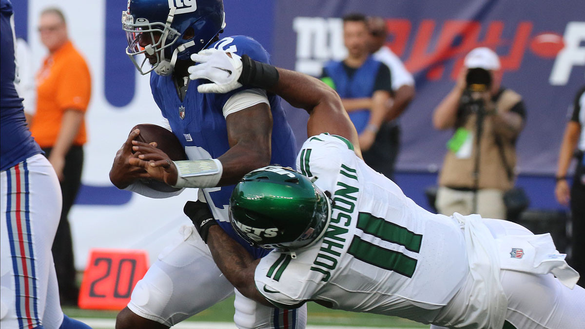 East Rutherford, NJ August 26, 2023 -- Jermaine Johnson II of the Jets tackles NY Giants quarterback Tyrod Taylor in the first half. New The NY Jets against the NY Giants on August 26, 2023 at MetLife Stadium in East Rutherford, NJ, as the rivals play their final preseason game before the start of the NFL season.