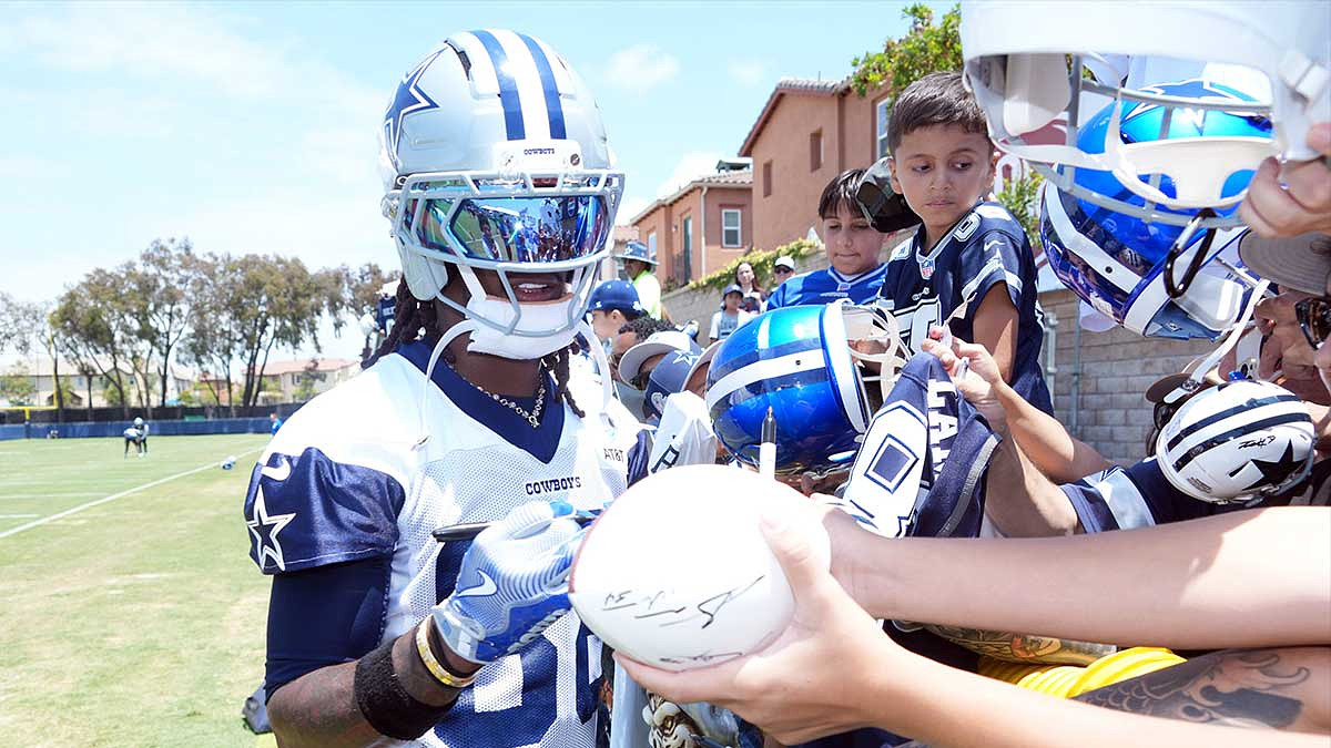 Dallas Cowboys receiver CeeDee Lamb (88) signs autographs during training camp at the River Ridge Fields.