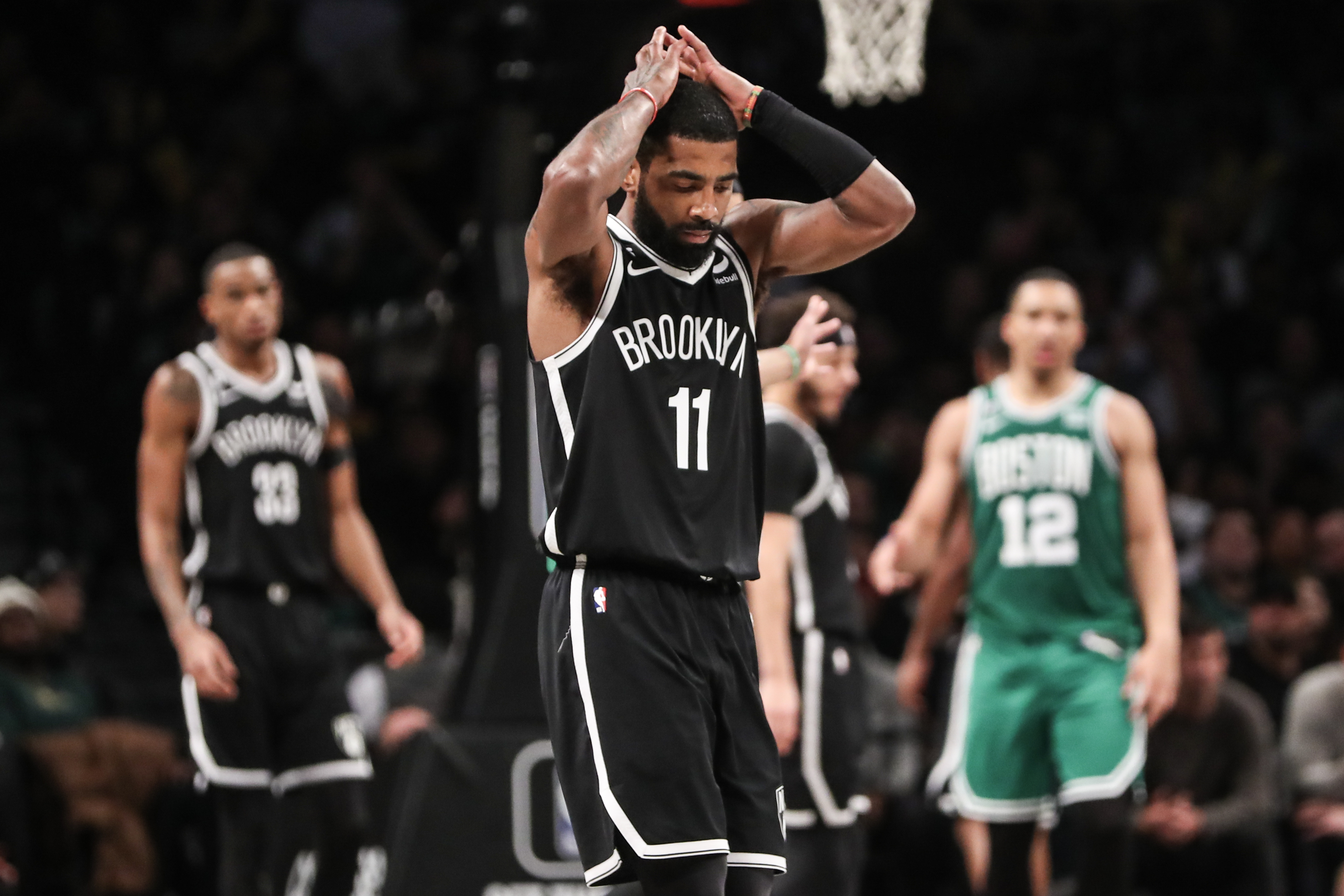 Brooklyn Nets guard Kyrie Irving (11) reacts after committing a foul in the fourth quarter against the Boston Celtics at Barclays Center.