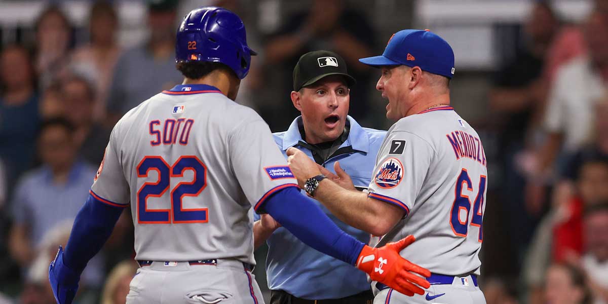 New York Mets right fielder Juan Soto (22) and manager Carlos Mendoza (64) talk to umpire Quinn Wolcott (81) against the Atlanta Braves in the ninth inning at Truist Park.