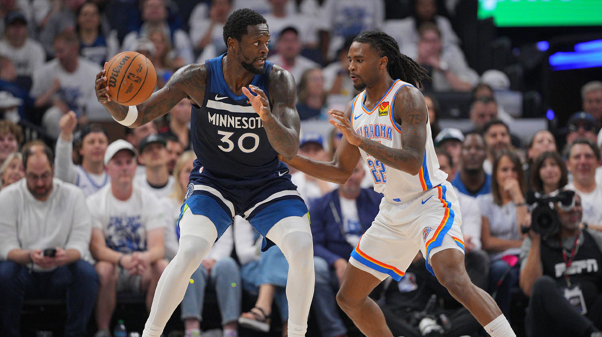 Minnesota Timberwolves forward Julius Randle (30) dribbles the ball against Oklahoma City Thunder guard Cason Wallace (22) during the first half in game three of the western conference finals for the 2025 NBA Playoffs at Target Center.