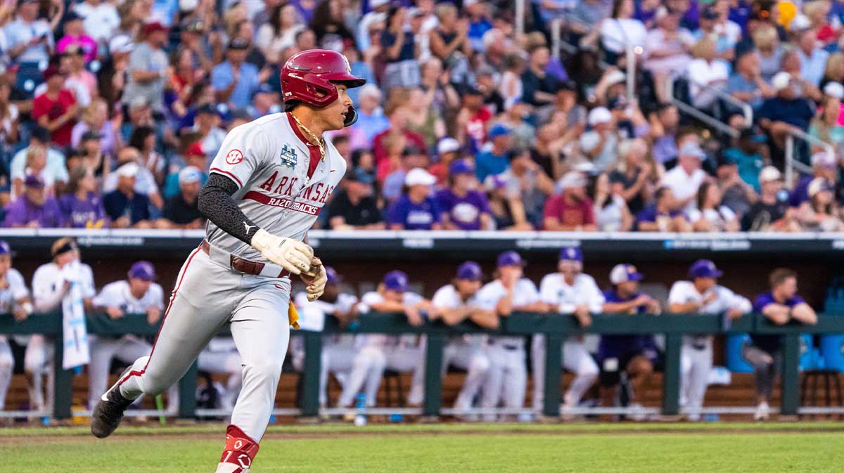 Jun 18, 2025; Omaha, Neb, USA; Arkansas Razorbacks shortstop Wehiwa Aloy (9) runs to first after hitting a single against the LSU Tigers during the eighth inning at Charles Schwab Field. Mandatory Credit: Dylan Widger-Imagn Images