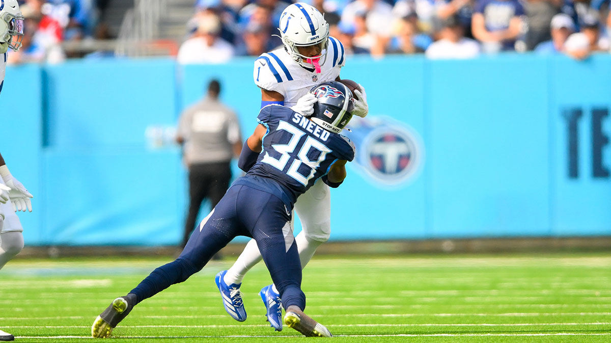 Indianapolis Colts wide receiver Josh Downs (1) runs the ball as Tennessee Titans cornerback L'Jarius Sneed (38) defends during the second half at Nissan Stadium.