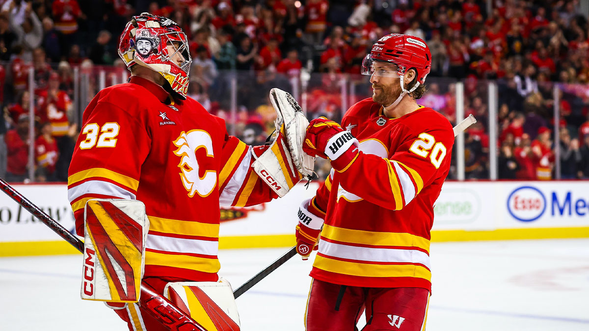 Calgary Flames goaltender Dustin Wolf (32) celebrate win with teammates after defeating Vegas Golden Knights at Scotiabank Saddledome.