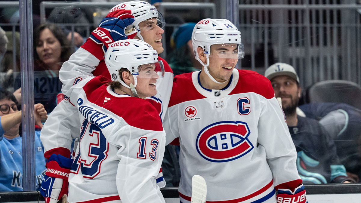 Montreal Canadiens forward Cole Caufield (13) forward Juraj Slafkovský (20) and forward Nick Suzuki (14) celebrate a goal during the second period against the Seattle Kraken at Climate Pledge Arena.