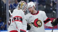 Ottawa Senators defenseman Jake Sanderson (85) celebrates with goaltender Linus Ullmark (35) after defeating the Toronto Maple Leafs during game five of the first round of the 2025 Stanley Cup Playoffs at Scotiabank Arena.