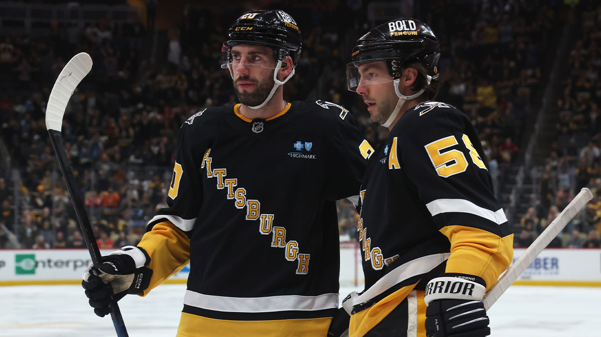 Pittsburgh Penguins defenseman Conor Timmins (20) and defenseman Kris Letang (58) celebrate a goal by Letang against the Chicago Blackhawks during the third period at PPG Paints Arena.