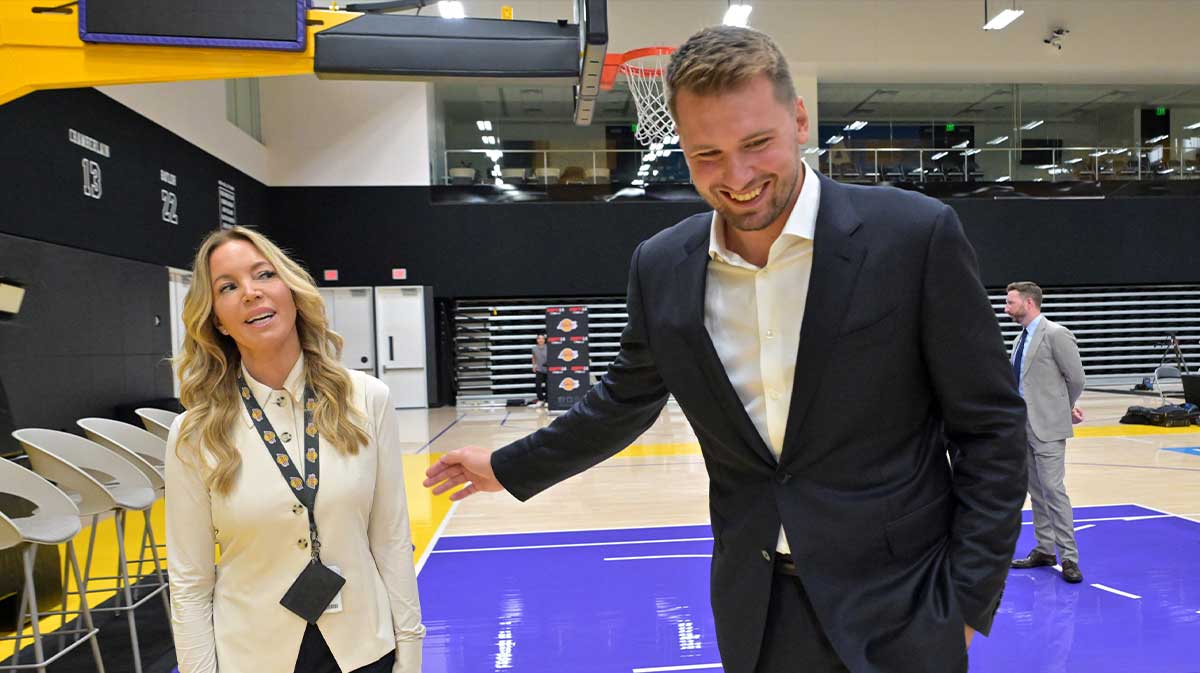 Lakers Luka Doncic (77) talks with team co-owner Jeanie Buss following a press conference announcing the signing of a 3-year, $165 million contract extension at UCLA Health Training Center