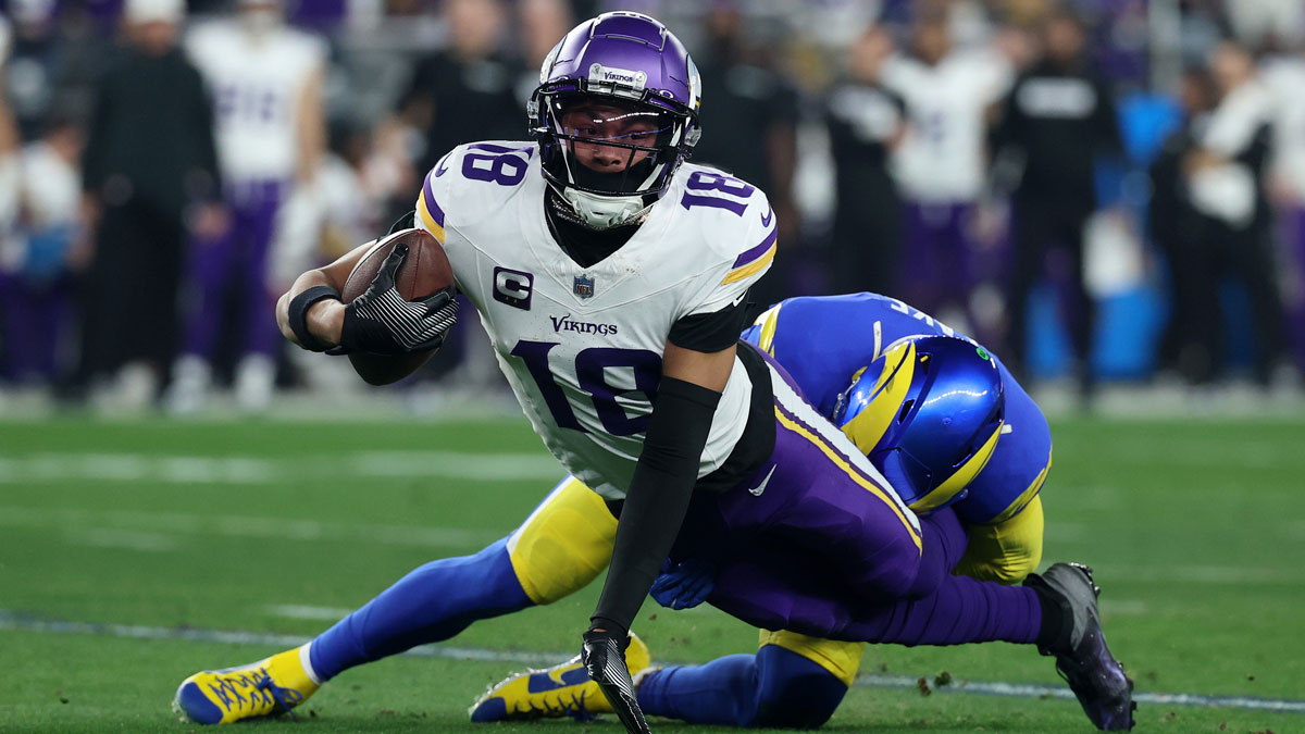 Minnesota Vikings wide receiver Justin Jefferson (18) makes a catch on Los Angeles Rams linebacker Nick Hampton (31) during the first half in an NFC wild card game at State Farm Stadium. 