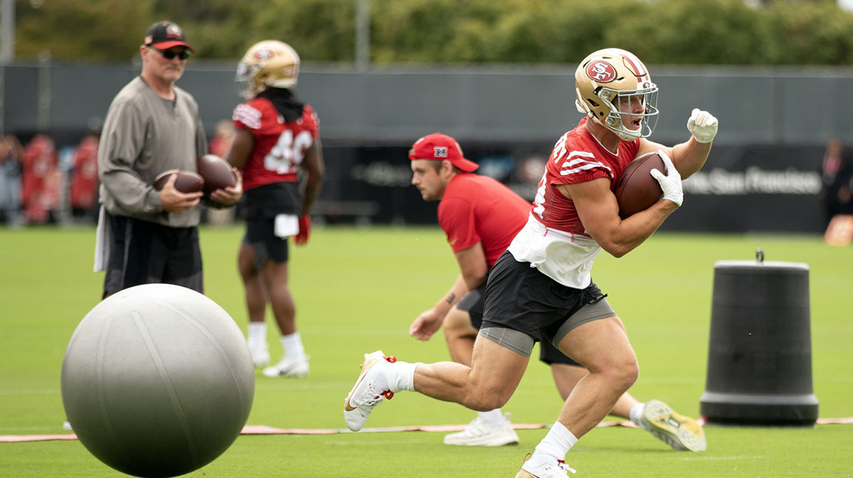 San Francisco 49ers running back Christian McCaffrey (23) runs through an obstacle course during the second day of training camp.