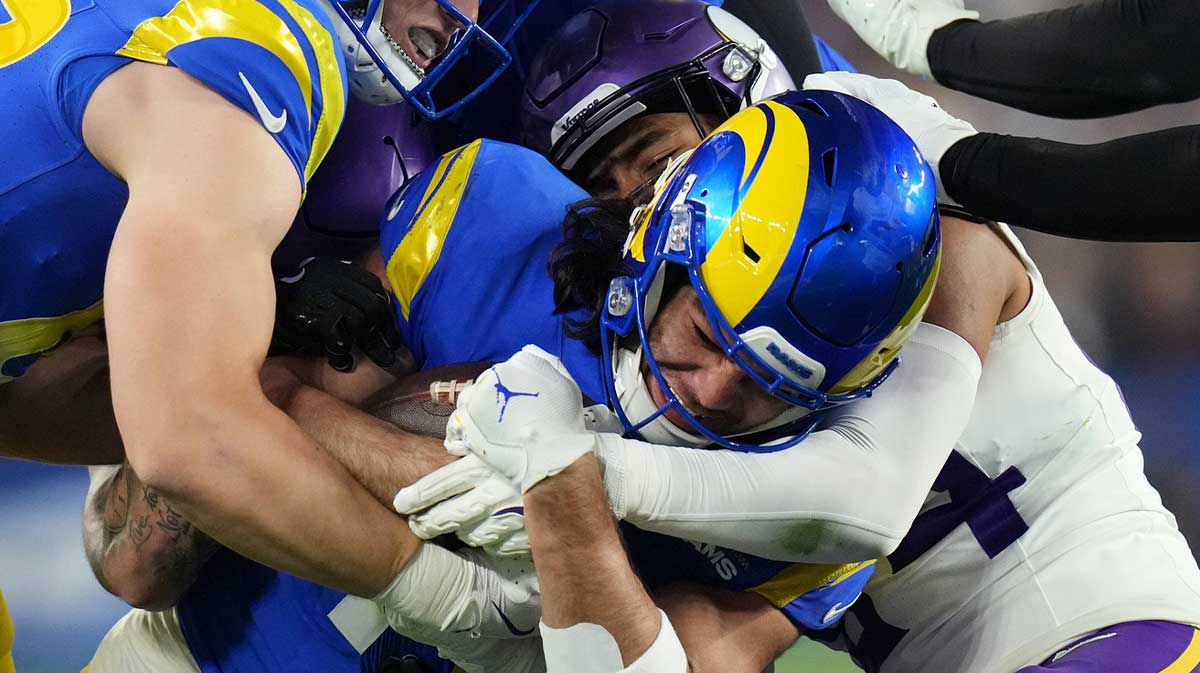 Los Angeles Rams receiver Puka Nacua (17) fights for extra yards after a catch against the Minnesota Vikings during their playoff game at State Farm Stadium on Jan. 13, 2025, in Glendale.
