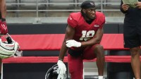 Arizona Cardinals receiver Marvin Harrison Jr. (18) watches from the sidelines during the team's practice at State Farm Stadium on July 29, 2025.